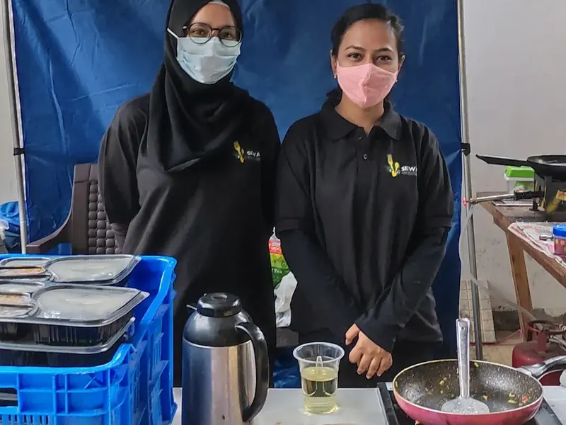 Two Sewan staff members at a serving counter